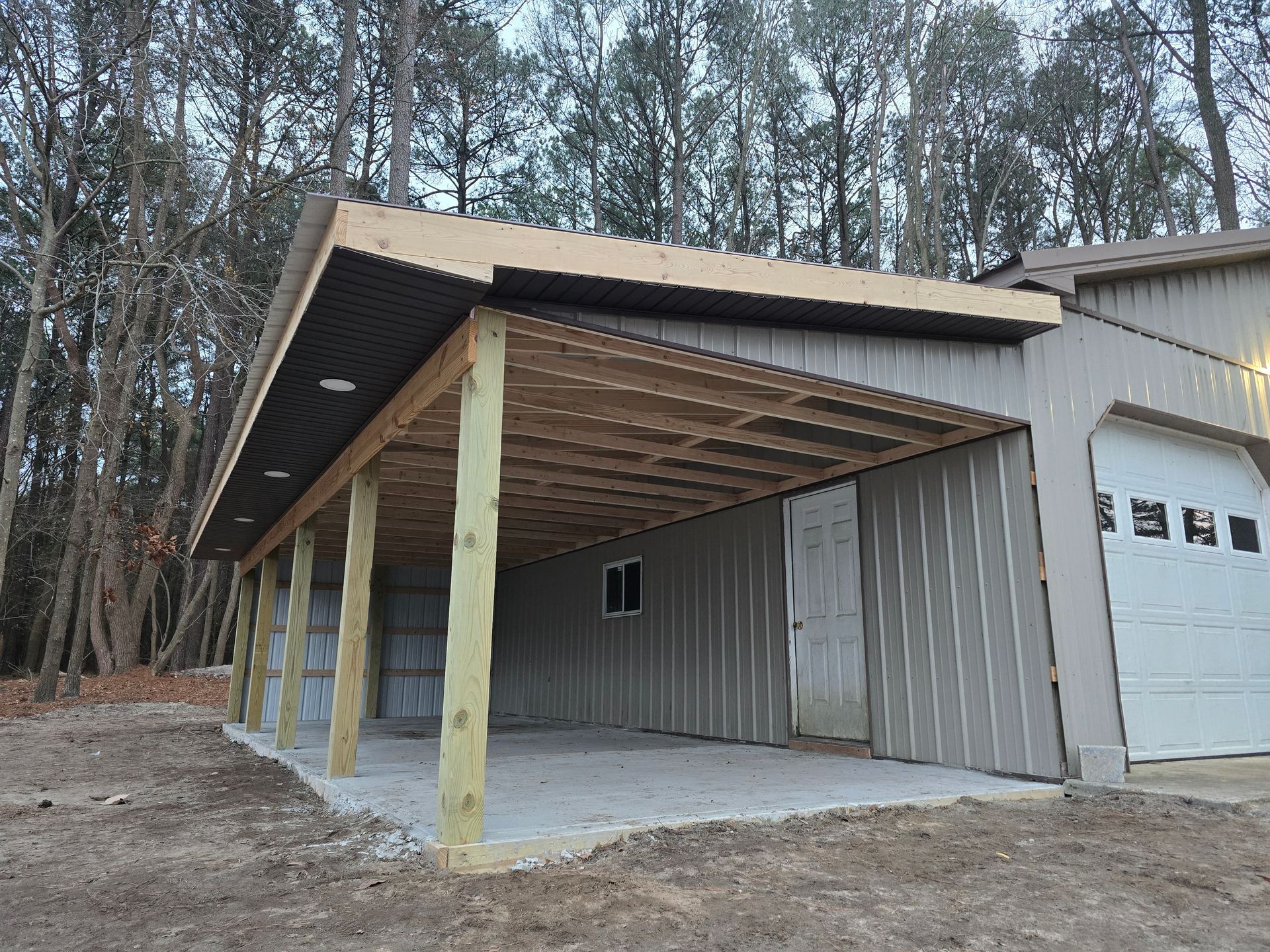 A garage with a wooden porch and a white garage door.