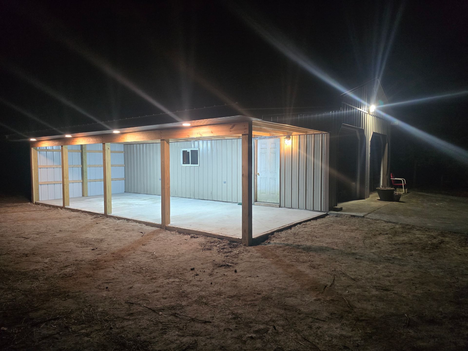 A garage is lit up at night with a lot of lights