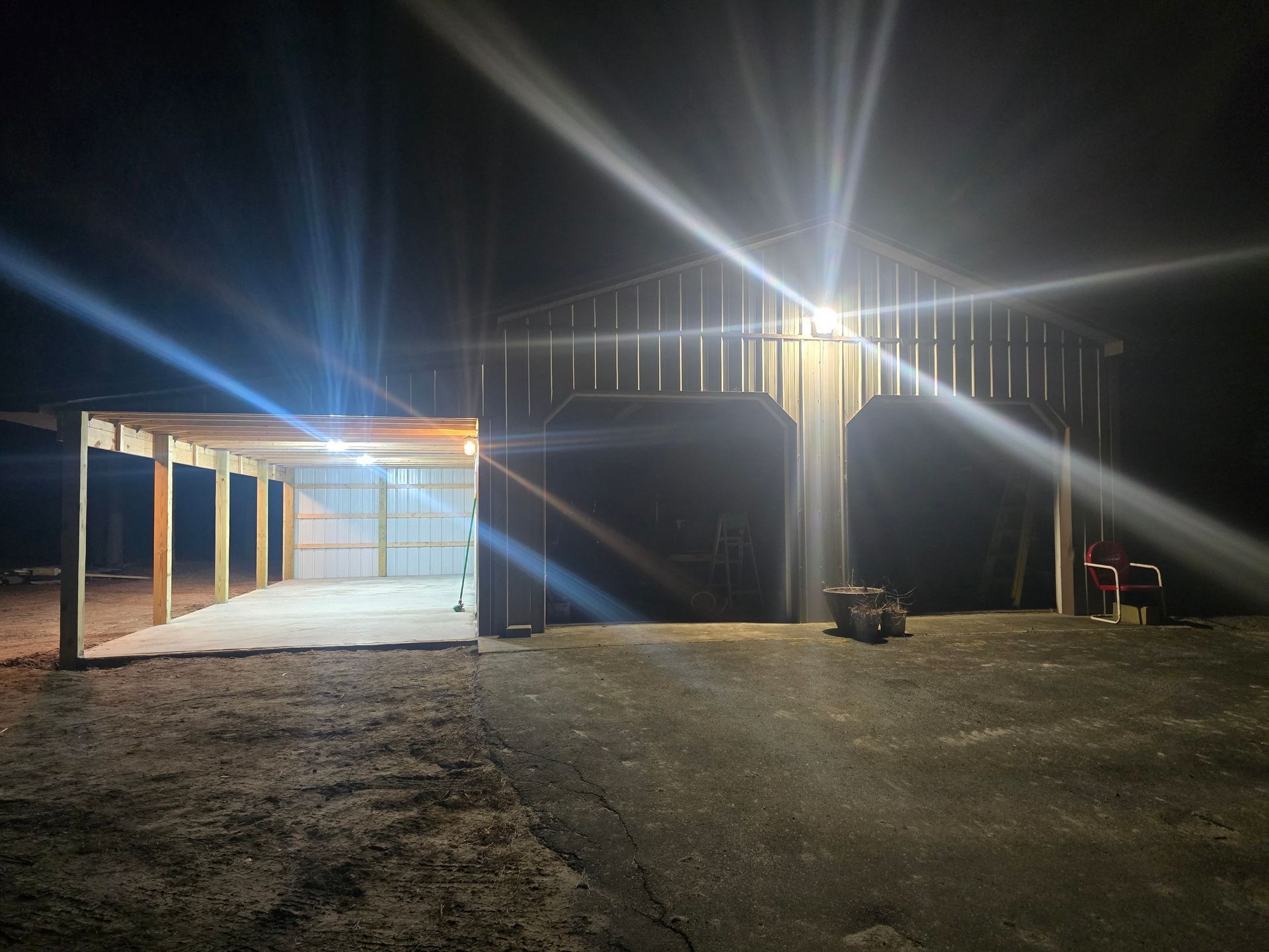 A garage is lit up at night with a lot of lights