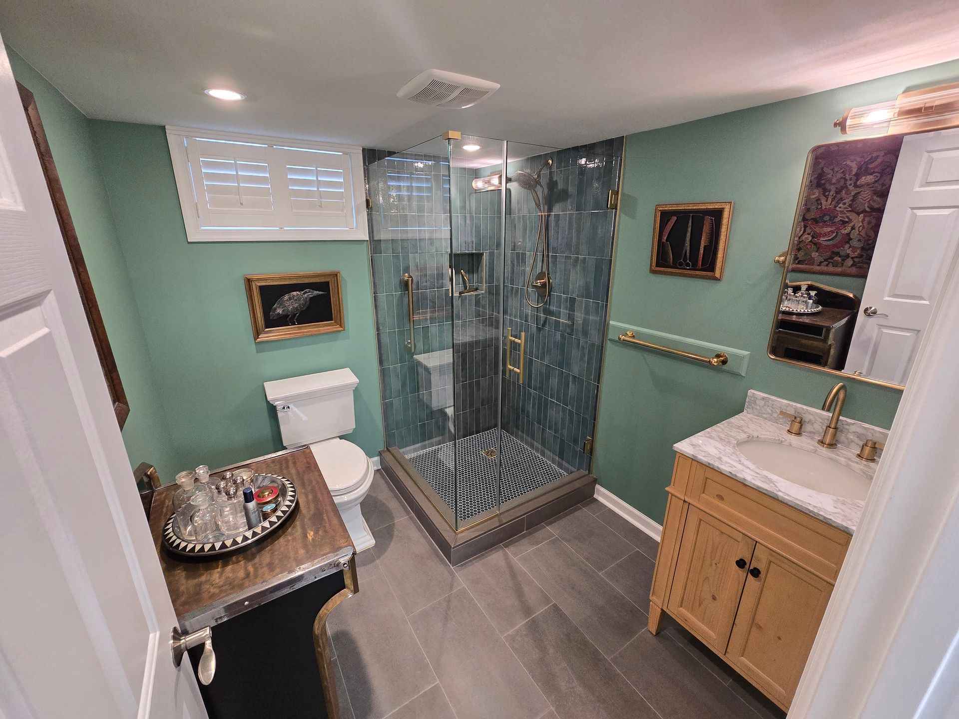 A bathroom with a toilet , sink , and walk in shower.