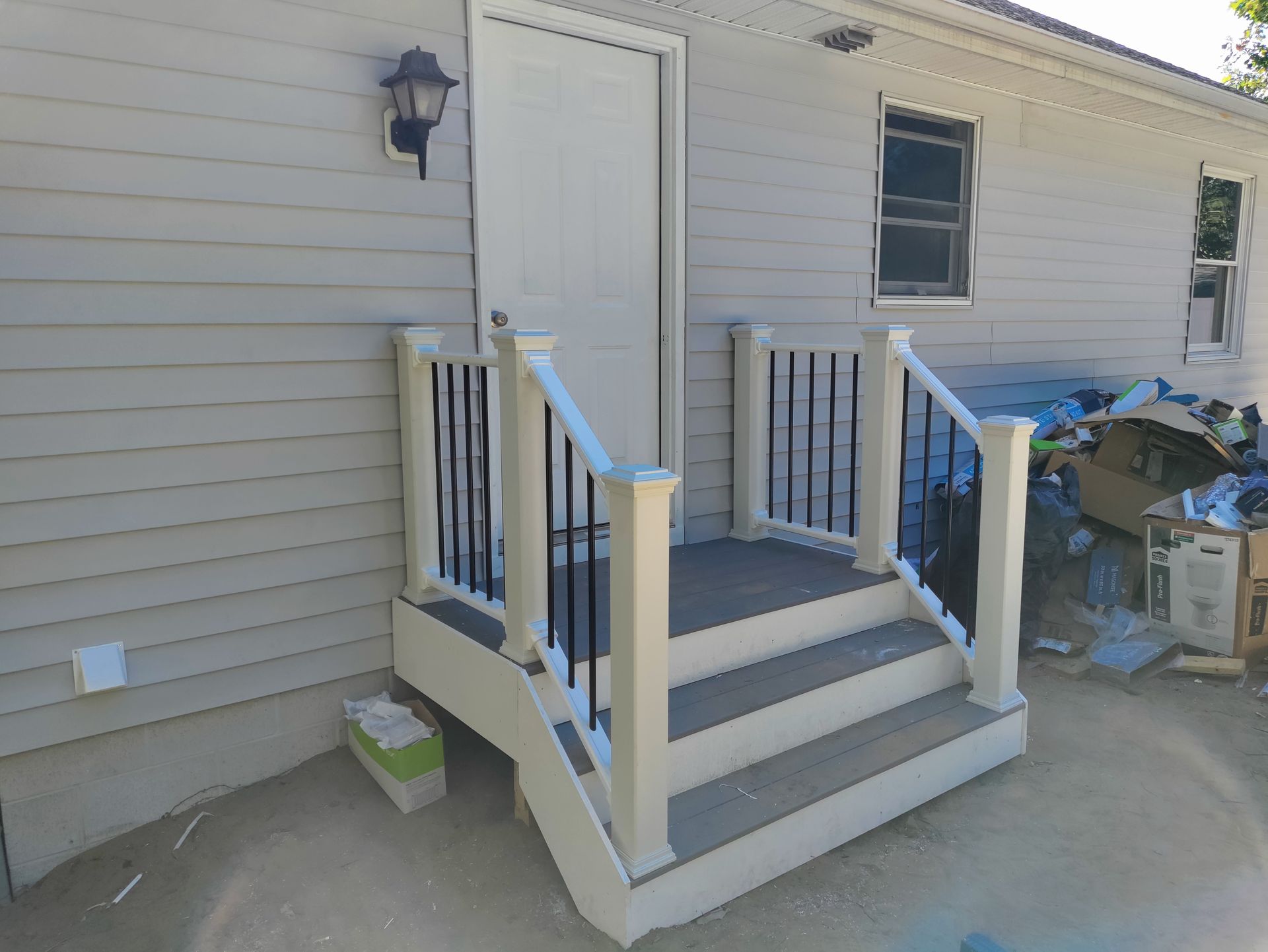A house with a porch and stairs leading up to it.