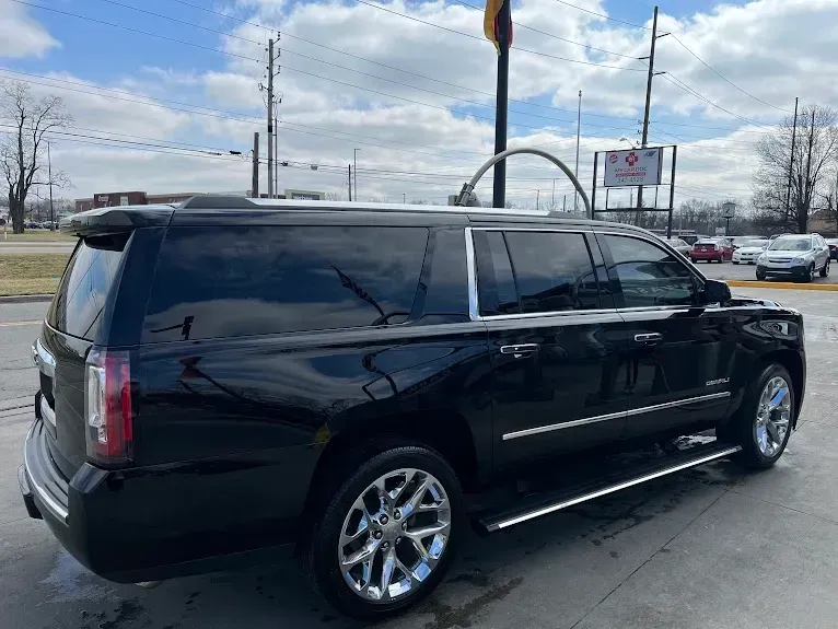 A black suv is parked in a parking lot.