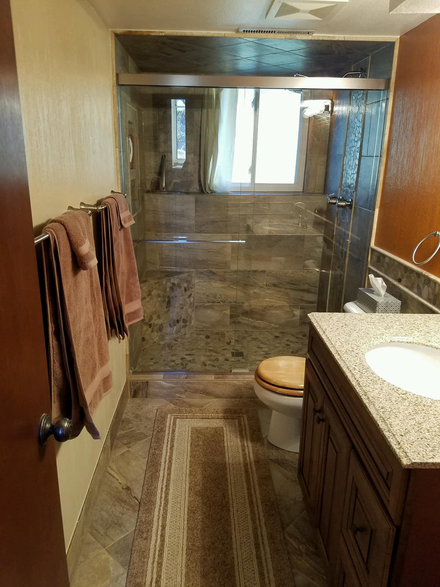 A bathroom with a toilet , sink , and shower.