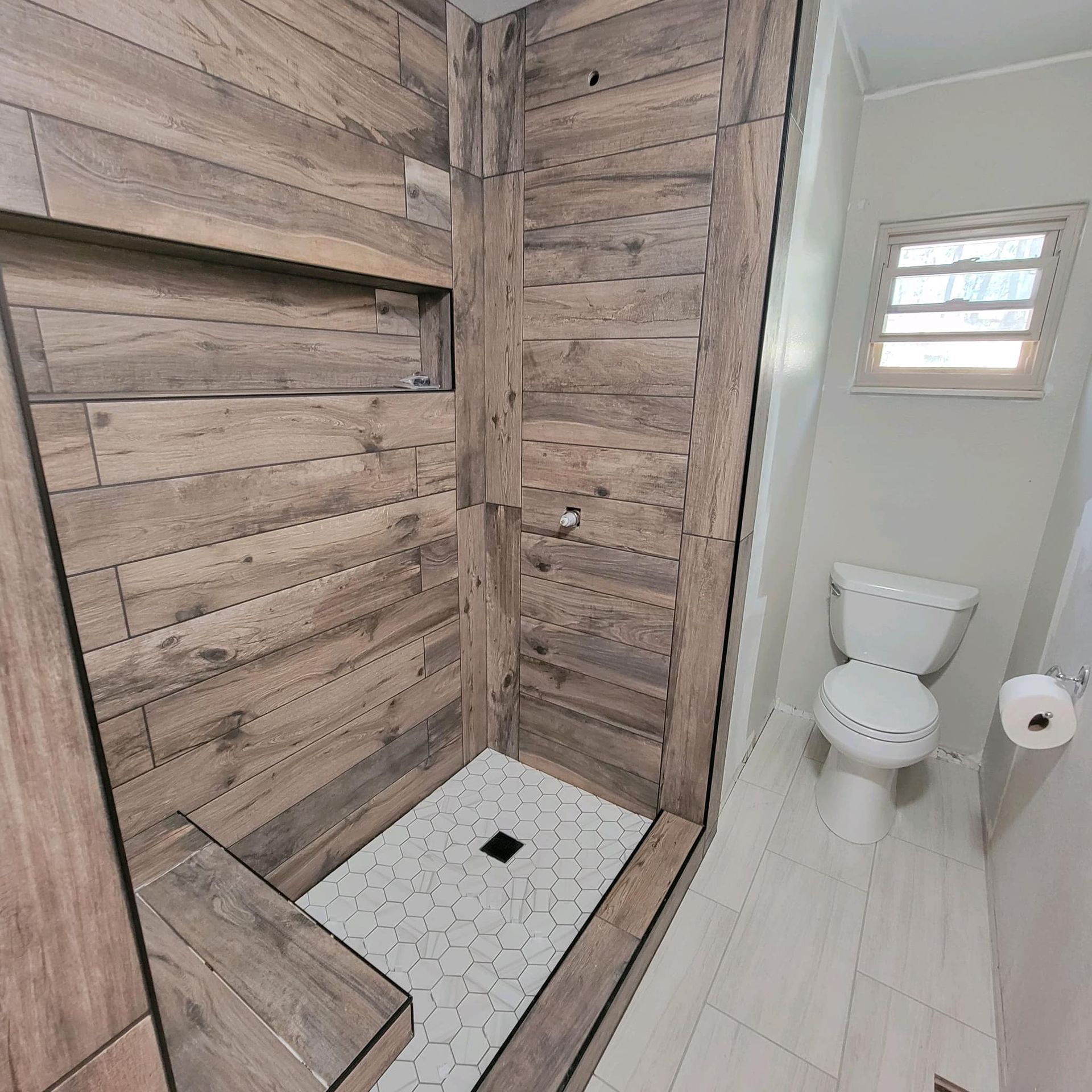 a bathroom with a walk in shower and a toilet