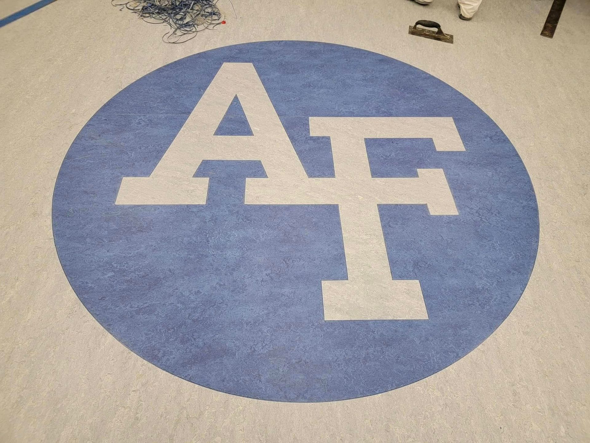 Air Force logo blue on white sports flooring