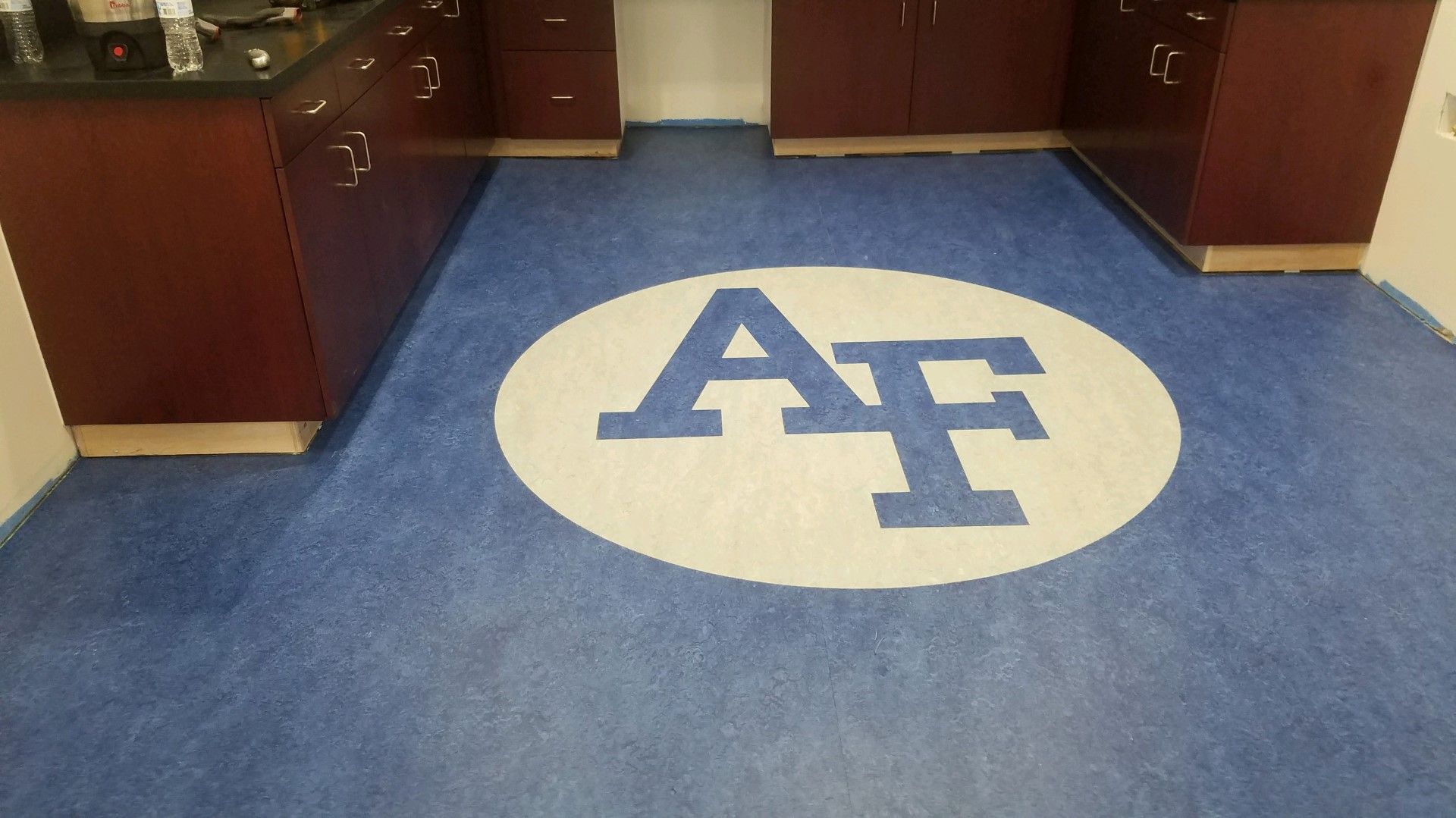 Air Force logo blue on white sports flooring