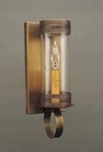 Brass wall sconce with cylindrical glass shade, candle-shaped light bulb, and hanging ring.