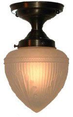 Antique bronze-colored ceiling light with frosted glass shade, illuminated from within.
