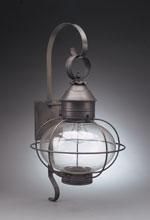 Black metal outdoor wall lantern with spherical glass and arched bracket.