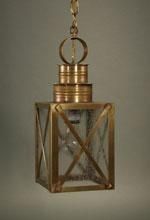 Brass lantern hanging from a chain; square body with glass panels and a decorative ring at top.