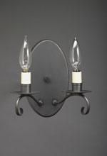 Black wall-mounted sconce with two candle-shaped light bulbs against a dark gray background.