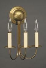 Brass wall sconce with three candle-shaped light bulbs.