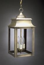 Hanging brass lantern with three light bulbs, against a gray background.