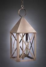 Hanging lantern with a copper-colored, pyramid-shaped top and crisscross wood frame, holding a candle-shaped light.