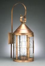 Copper-toned outdoor wall lantern with a curved arm and clear, beveled glass panels.