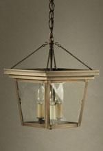 A bronze-toned lantern pendant light with clear glass panels, three bulbs, and a chain for hanging.