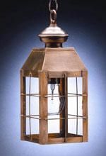 Copper-framed hanging lantern with glass panels and a single lightbulb.