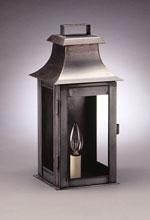 Metal lantern with a curved roof, rectangular body, and a lightbulb inside.