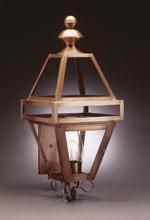 Copper outdoor wall lantern with glass panels.