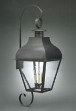Dark metal outdoor wall lantern with clear glass panels, curved bracket, and small ring at top.