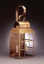 Copper wall lantern with a curved handle and glass panels.