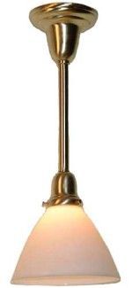Brass pendant light with a white, conical shade, illuminated.