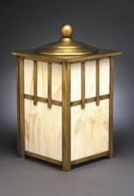 Square Arts and Crafts-style lamp with a brass frame, white panels, and a dome-topped lid, set against a dark backdrop.