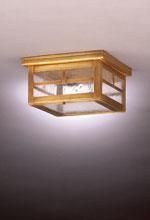 Wooden flush mount ceiling light fixture. Rectangular, glass panels, golden-brown frame. Lit from within.