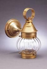 Brass wall-mounted outdoor light fixture with a clear, ribbed glass globe.