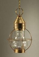 Brass hanging lantern with clear glass enclosure and protective wire frame.