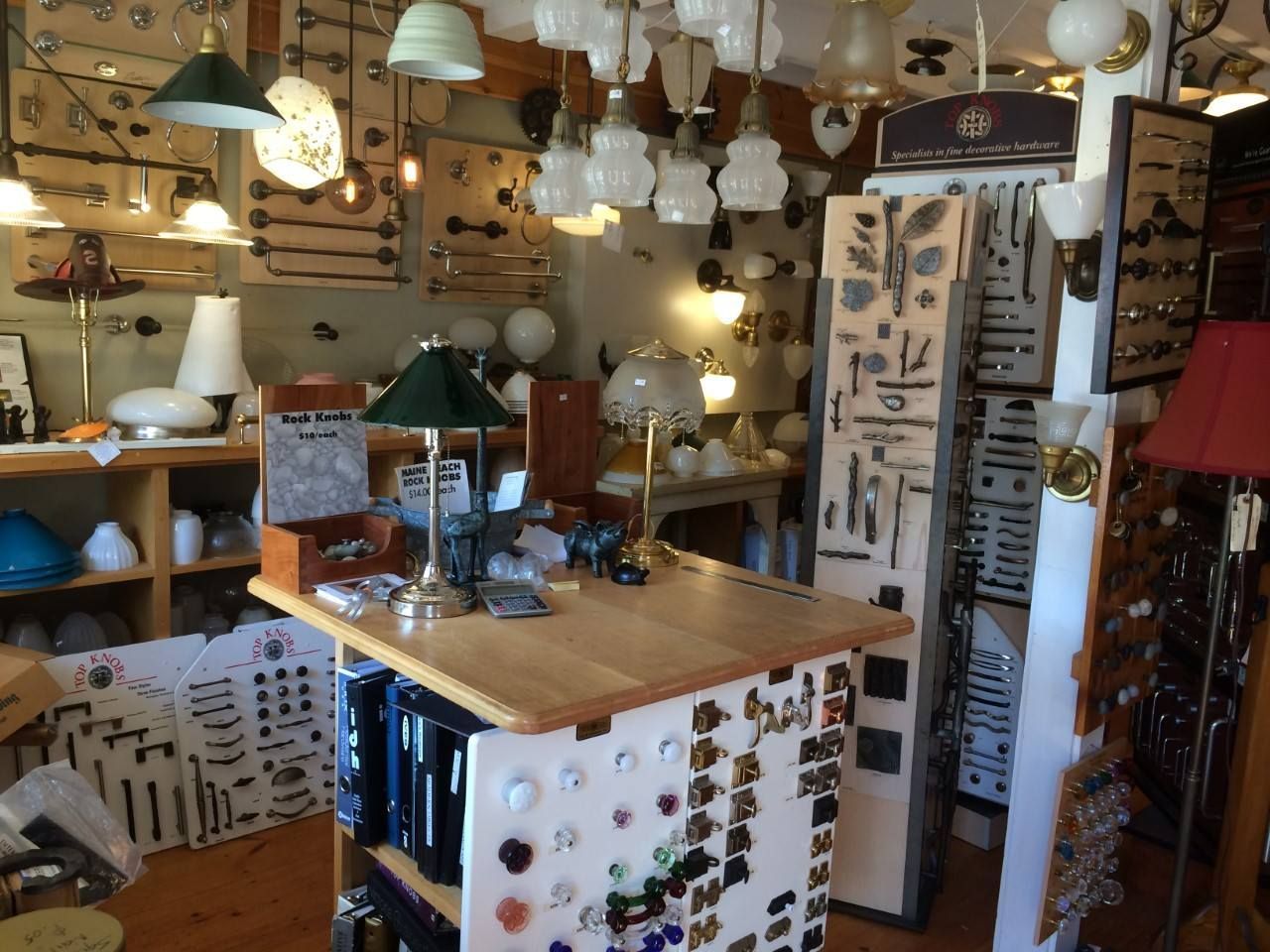 Interior of a lamp shop; various lamps on display, including overhead and table lamps.