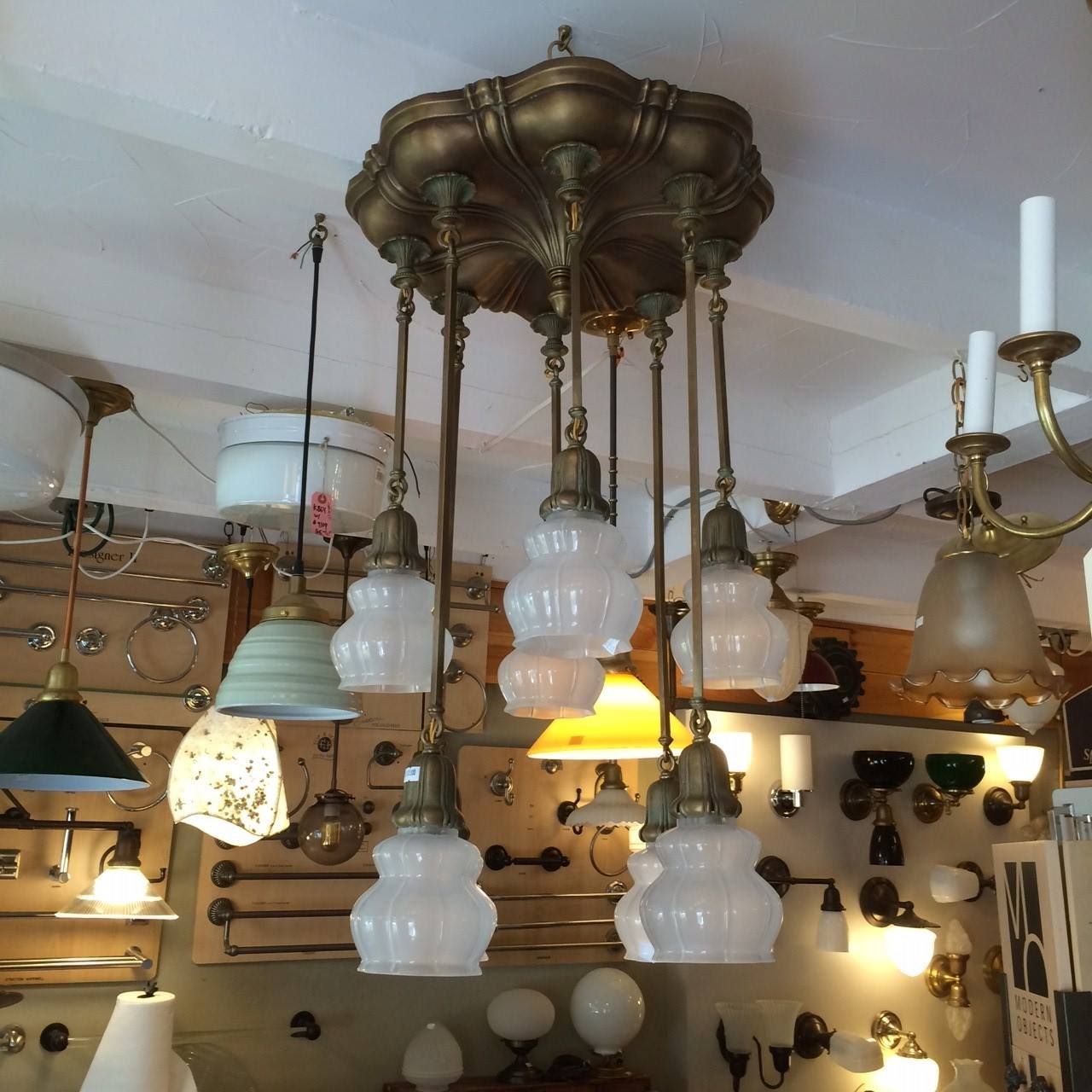 Antique ceiling light fixture with multiple frosted glass shades.