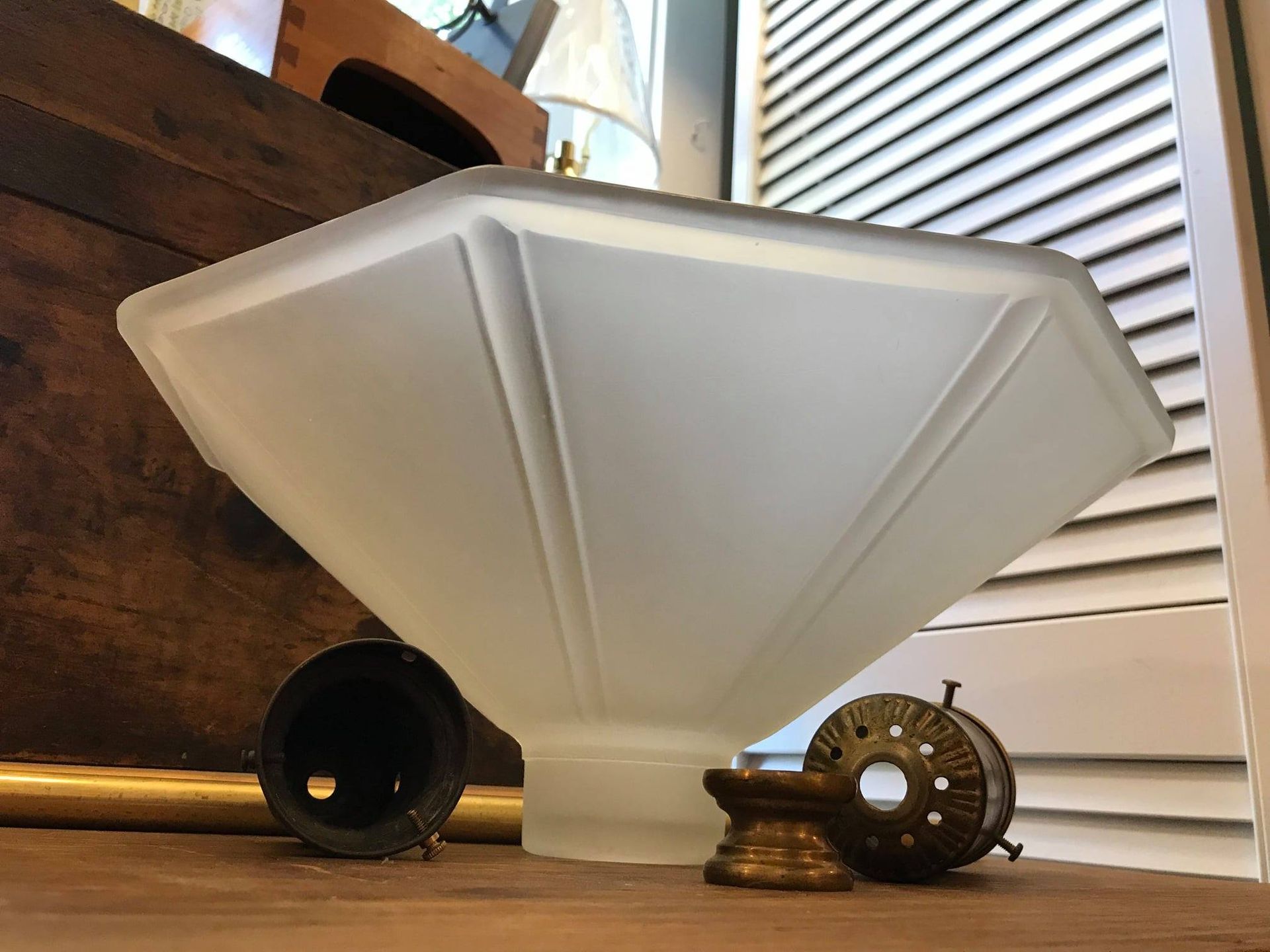 Frosted glass lamp shade with Art Deco design and brass hardware.