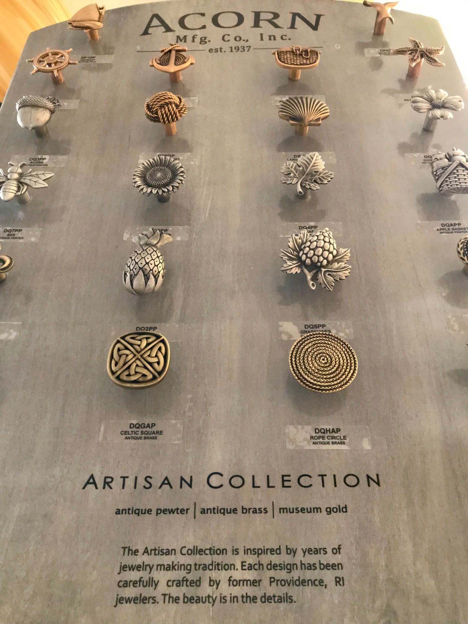 Display of antique brass cabinet knobs from Acorn Mfr. Co. Artisan Collection.