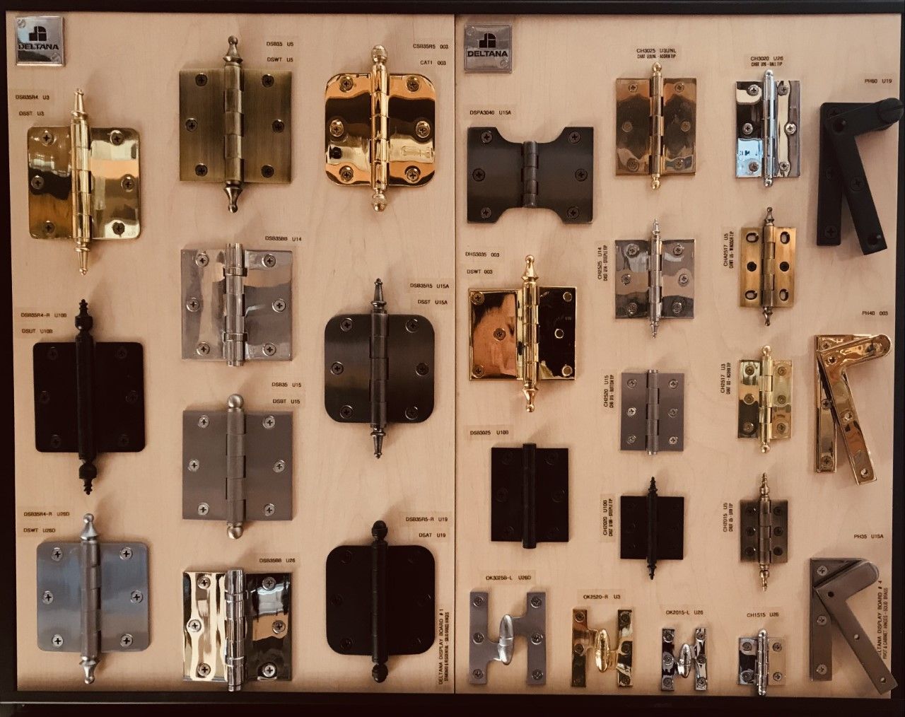 Display of various door hinges in different styles and finishes.