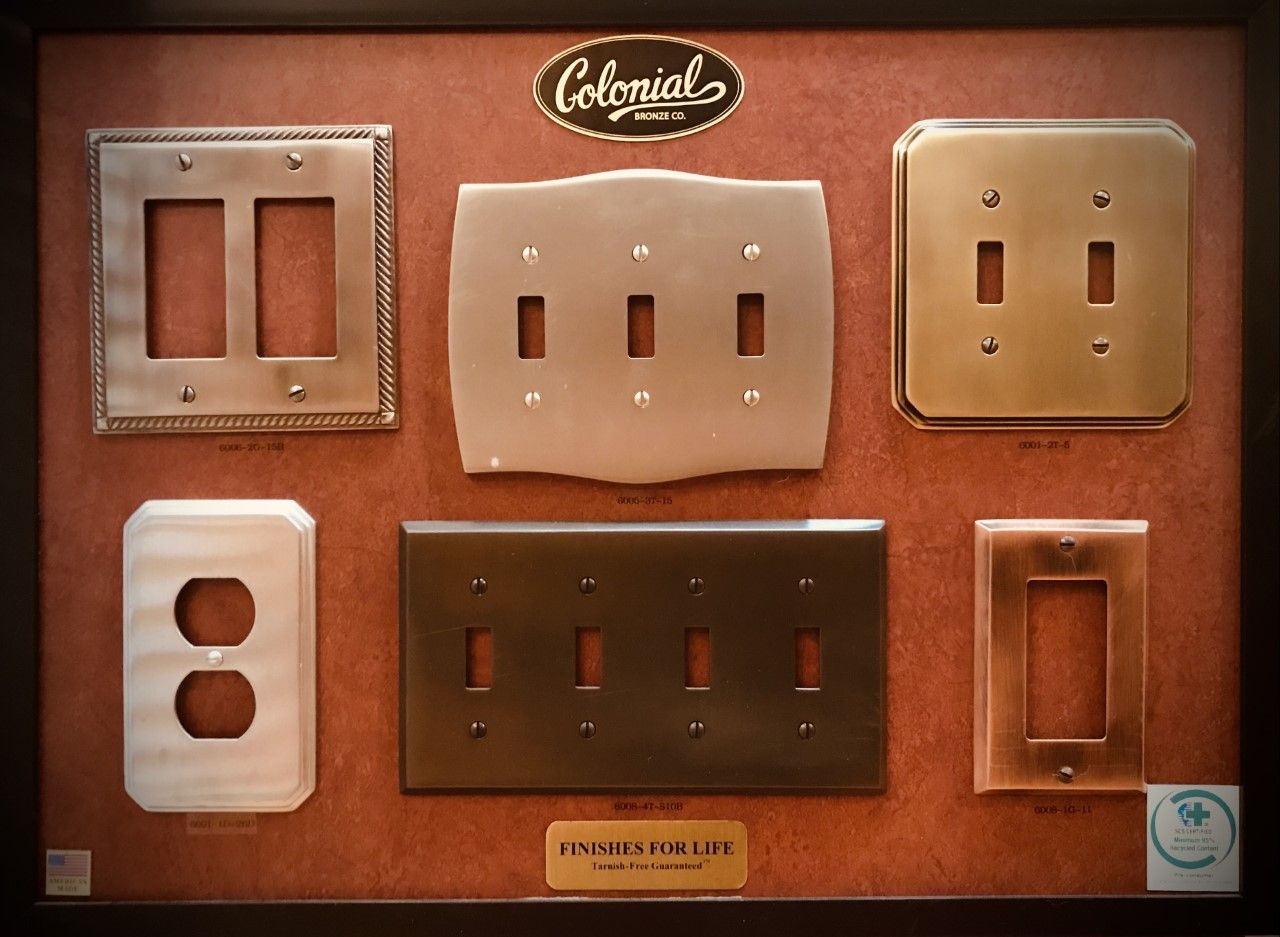 Display of Colonial Bronze light switch plates, various styles and finishes.