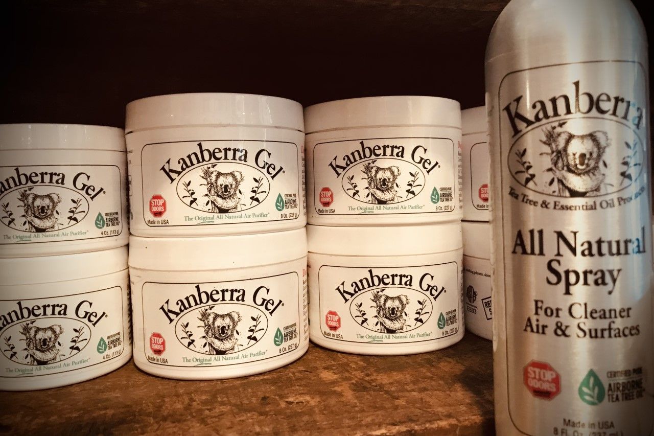 Shelves with white canisters and a spray bottle labeled 