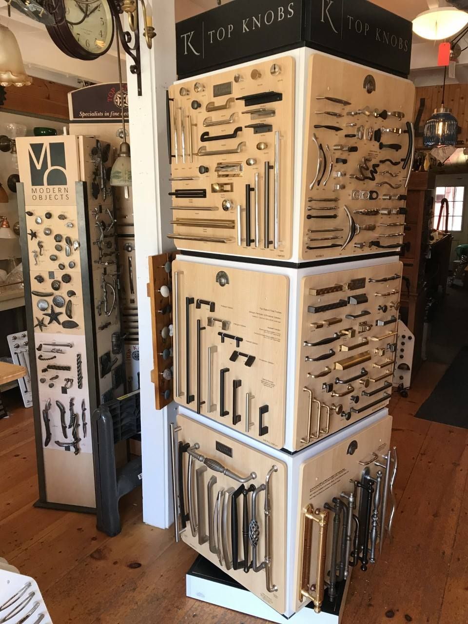 Display of cabinet hardware samples in a shop, organized on stacked wooden blocks.