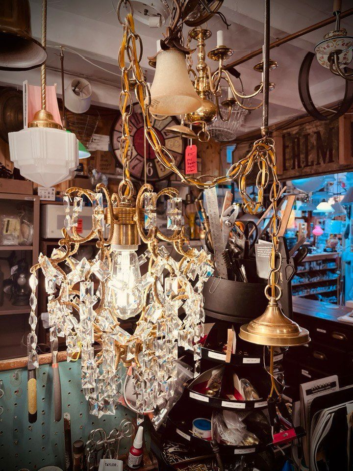 Antique shop interior with ornate chandeliers and various light fixtures.