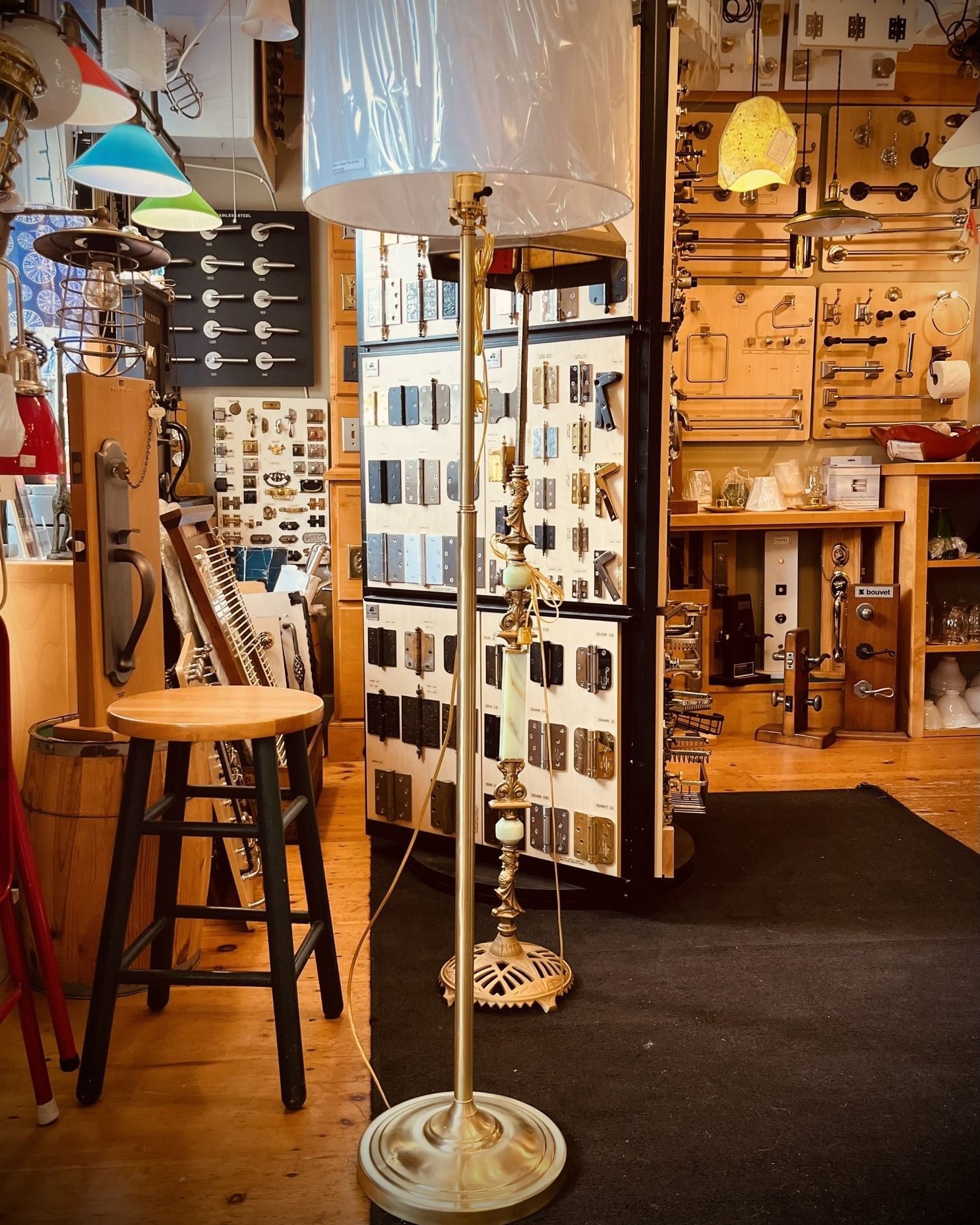 Floor lamp in a hardware store, surrounded by displays of various hardware items.