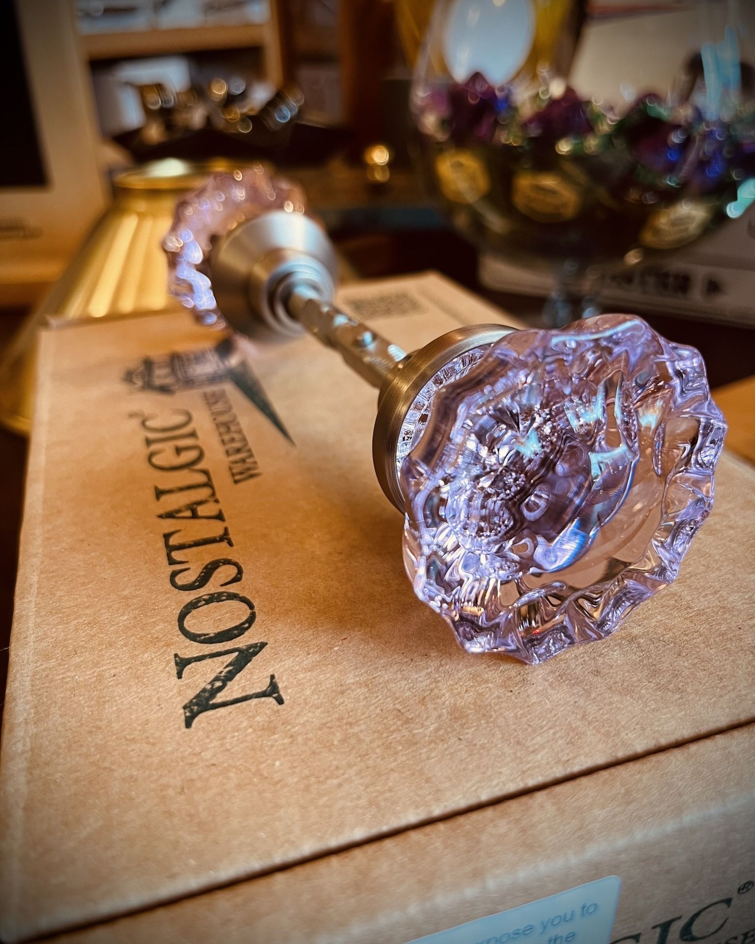 Pink glass doorknob on a box from Nostalgic Warehouse.