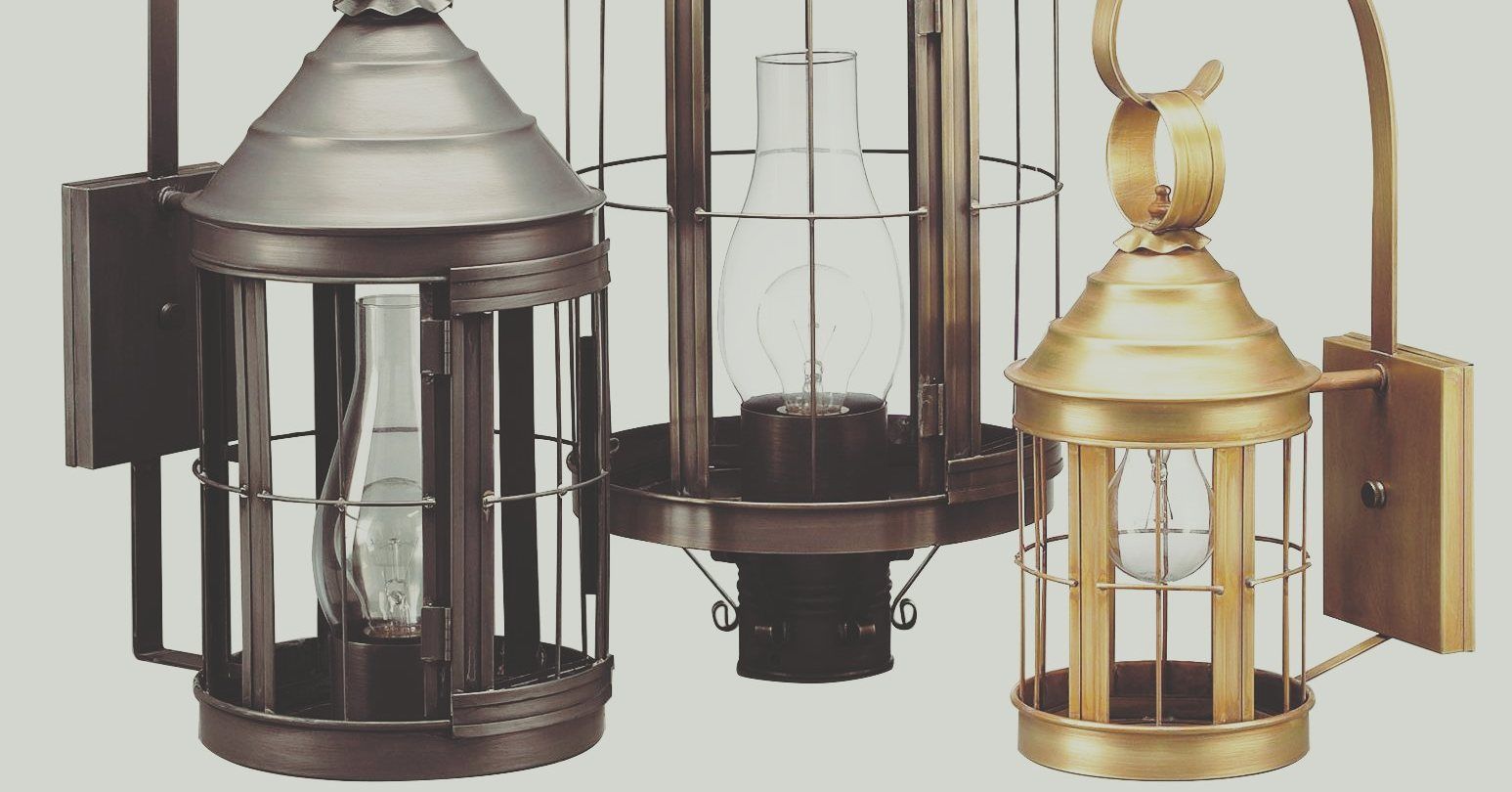 Three metal cage-style outdoor sconce lights in silver, bronze, and gold.
