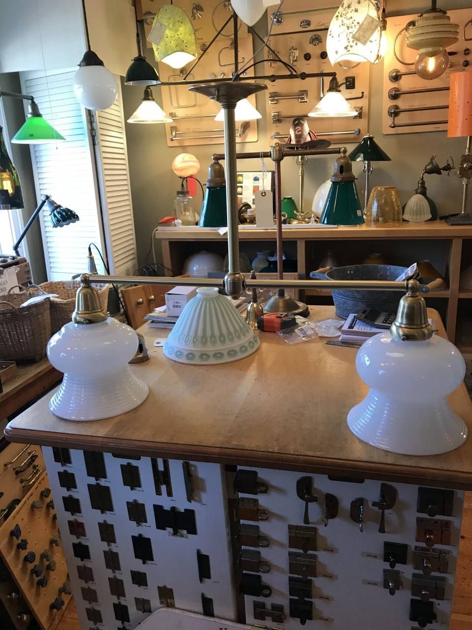 A display of antique lamps and hardware at a store with various lighting styles and fixtures.