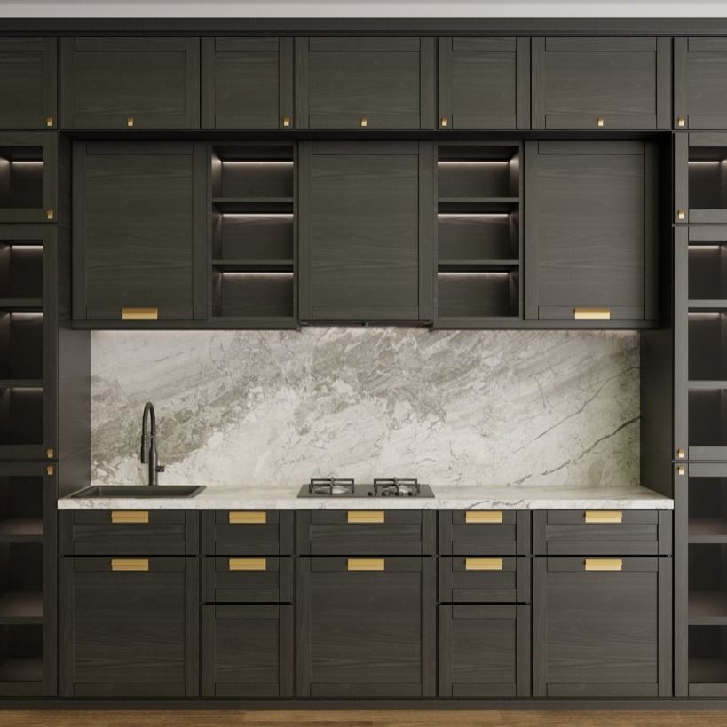 Dark gray kitchen cabinets with gold hardware, marble backsplash, and built-in appliances.