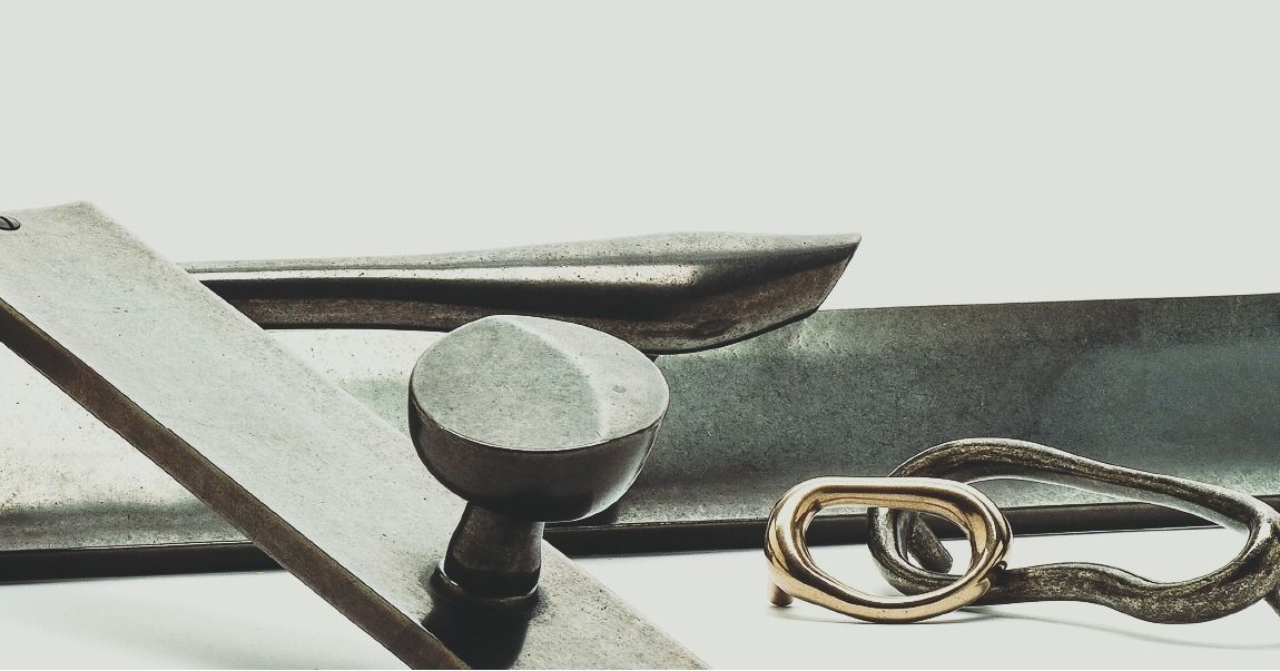 Gray metal components and gold loop on white.