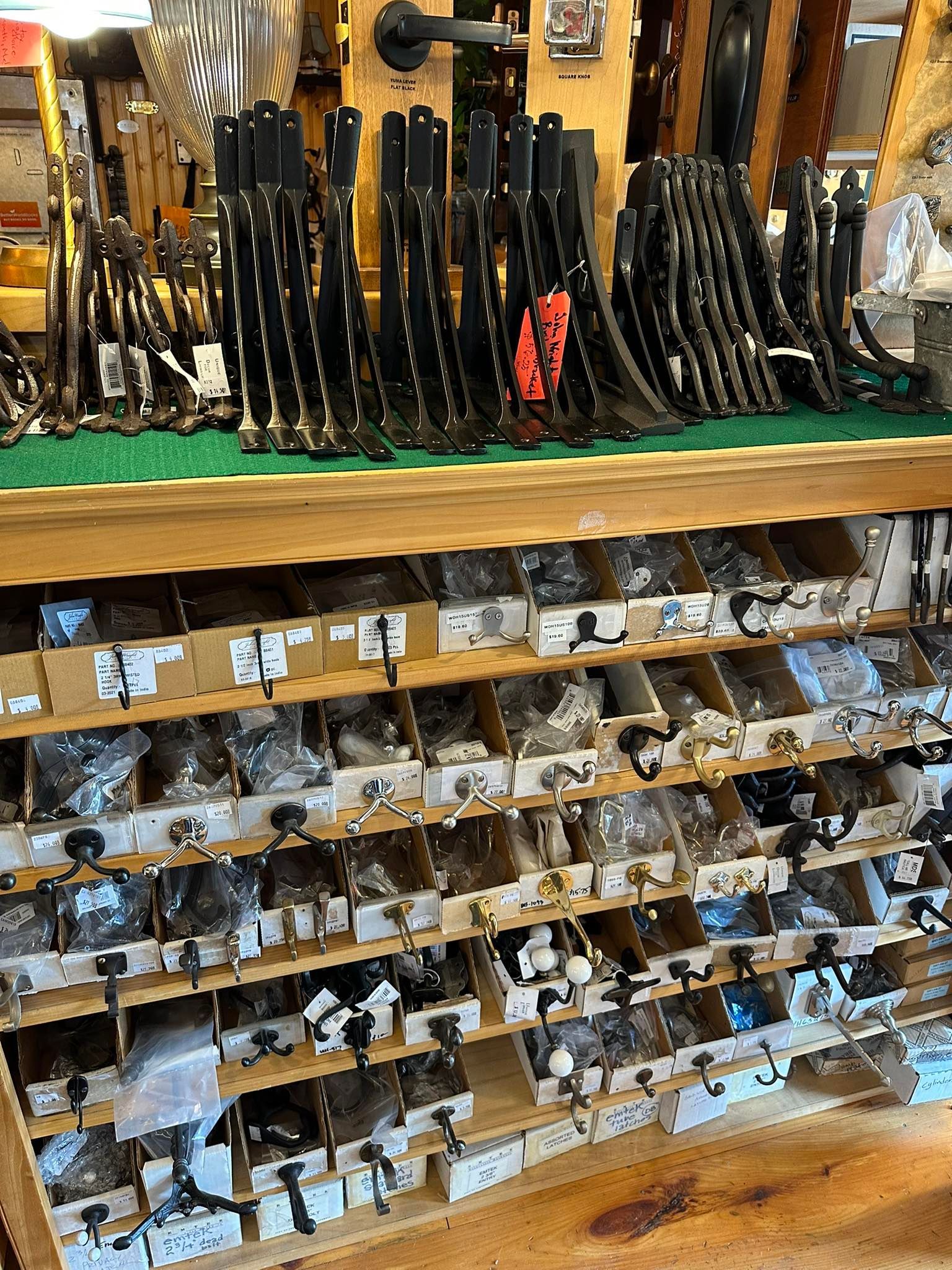 Shelves stocked with auto parts, including black metal brackets and small bagged components.