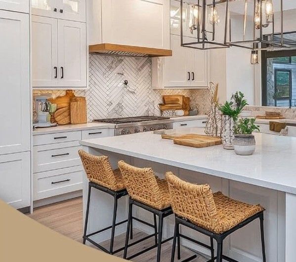 White kitchen with island, three rattan bar stools, herringbone backsplash, and wood range hood.