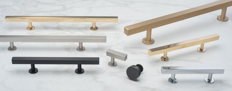 Cabinet hardware in various metallic finishes and styles, including pulls and knobs.