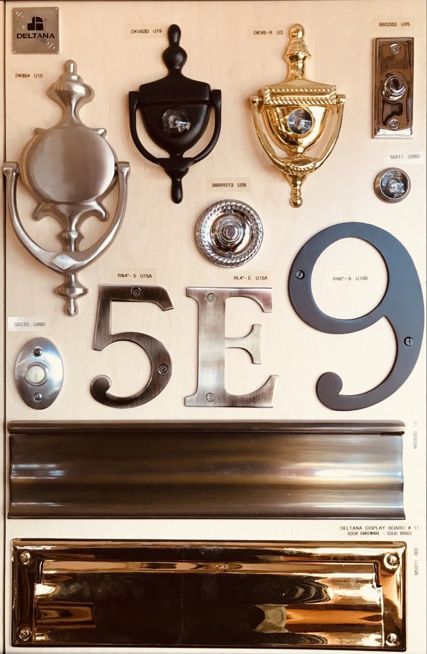 Door hardware display featuring knockers, numbers, and letter