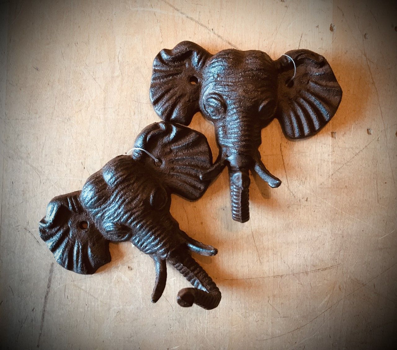 Two cast iron elephant head wall decorations.
